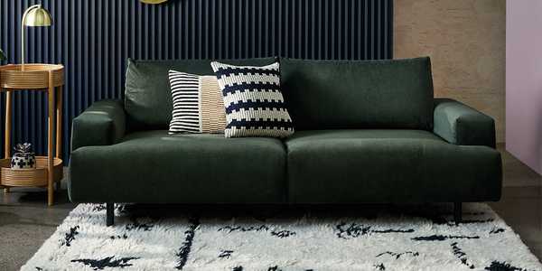 The dark green Habitat Julien 3-seater fabric sofa in a glam lounge setting.